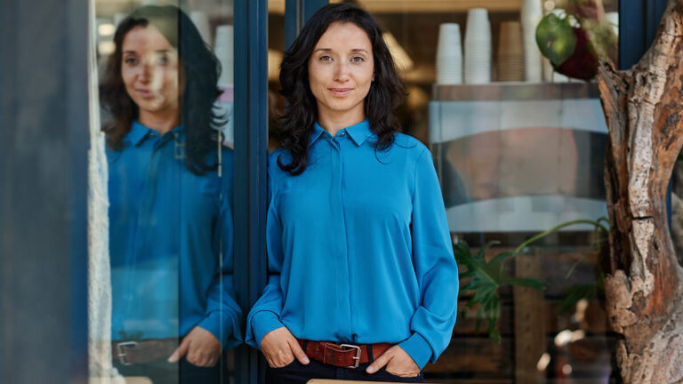 Standing woman looking at a camera.