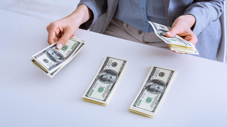 Three piles of $100 bills.