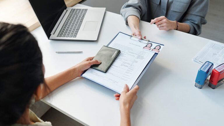Woman receiving immigration paperwork.