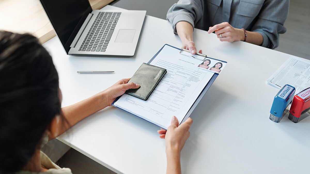 Woman receiving immigration paperwork.