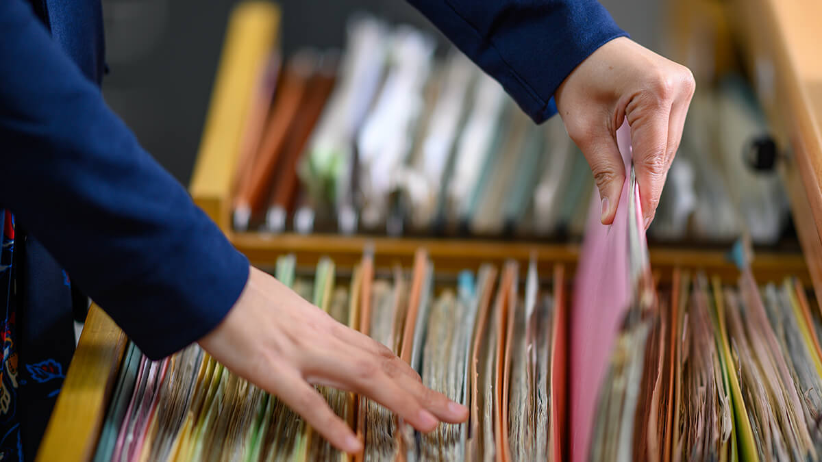 Employer putting away an employee file.
