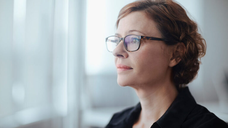 Woman staring sadly in the distance.