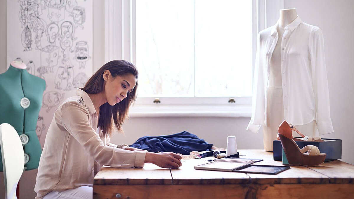 Sole Proprietor working on fashion sketches.