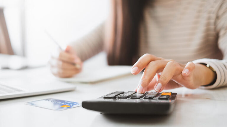 Woman using calculator.