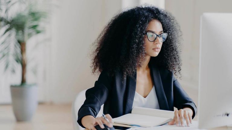 Woman reviewing year-to-date payroll earnings.