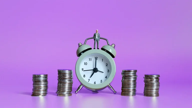 Alarm clock surrounded by coins on a purple background