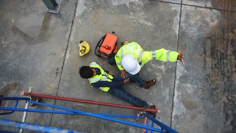 Construction worker on the ground with an injured leg